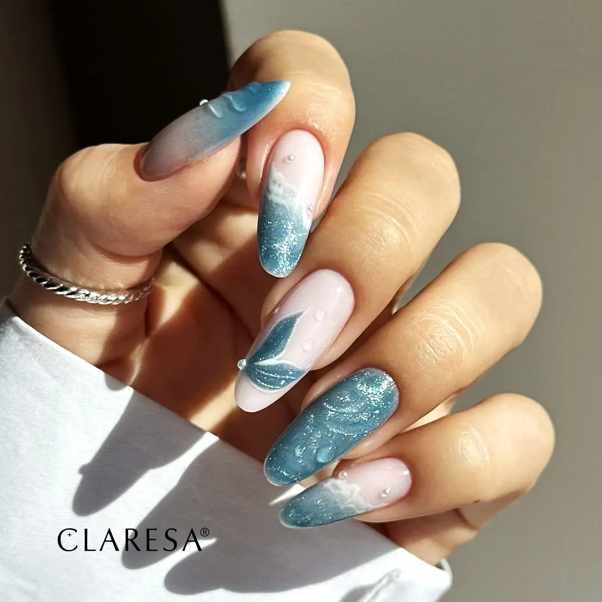 Turkusowo-różowy manicure cat eye z błyszczącymi zdobieniami